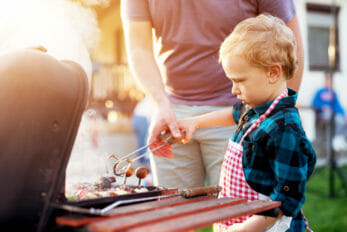 Son grilling with dad